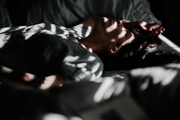 A woman lying awake in bed