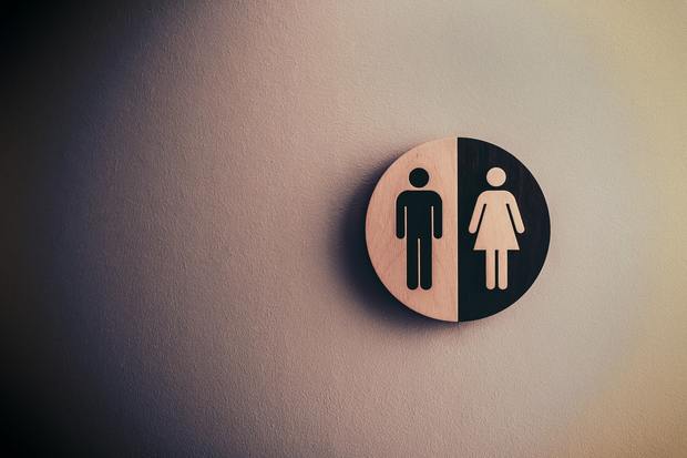 A sign for male and female washrooms on a wall