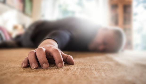 A man lies face down on the floor unconscious
