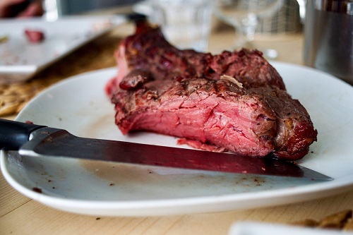A half-eaten steak on a white plate