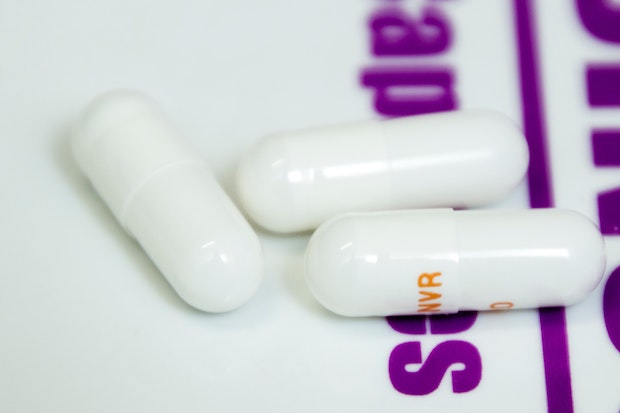 three white drug capsules